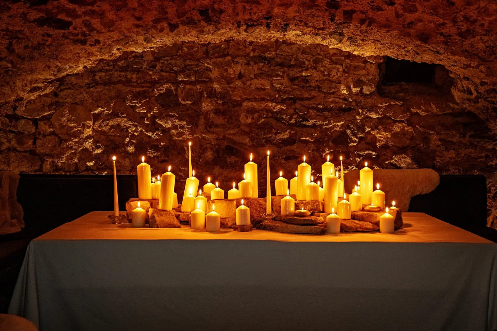 Table aux chandelles sous les voûtes de pierre du château des Monts d'Or