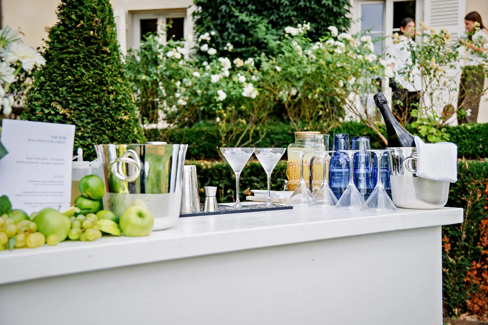Cocktail bar set in the gardens of a château, fine glassware and martini glasses
