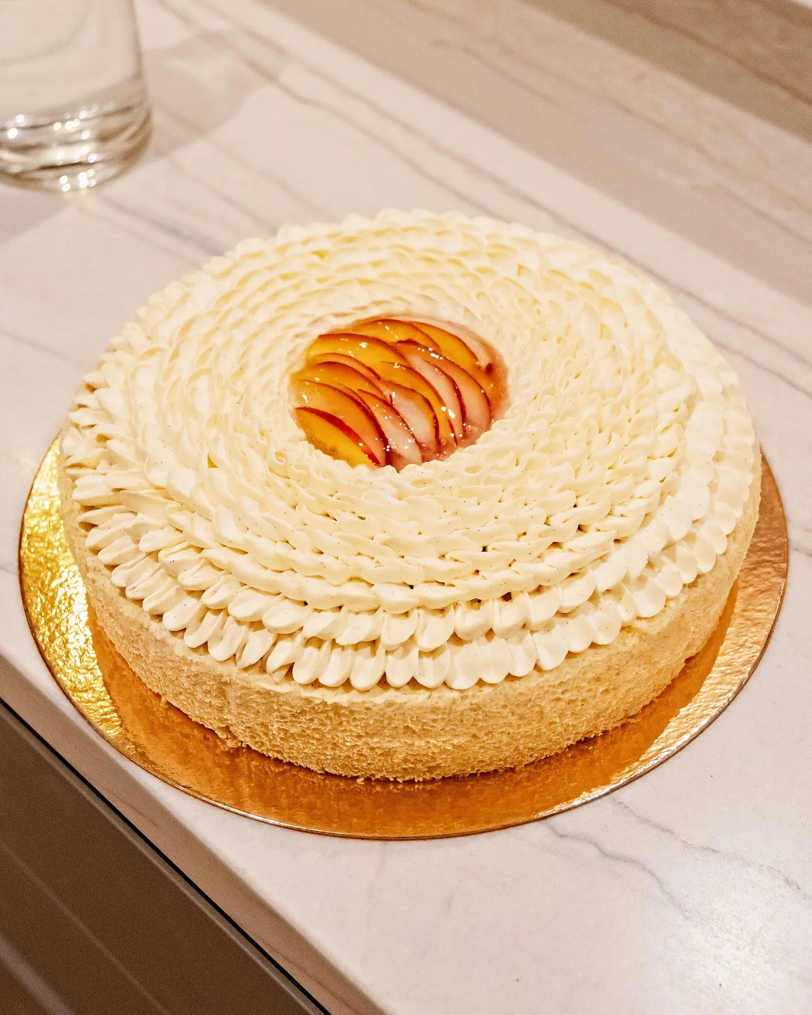 Vanilla entremets decorated with spiralled piped cream petals